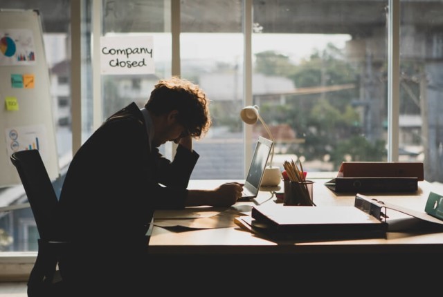 Businessman stressed with company closed